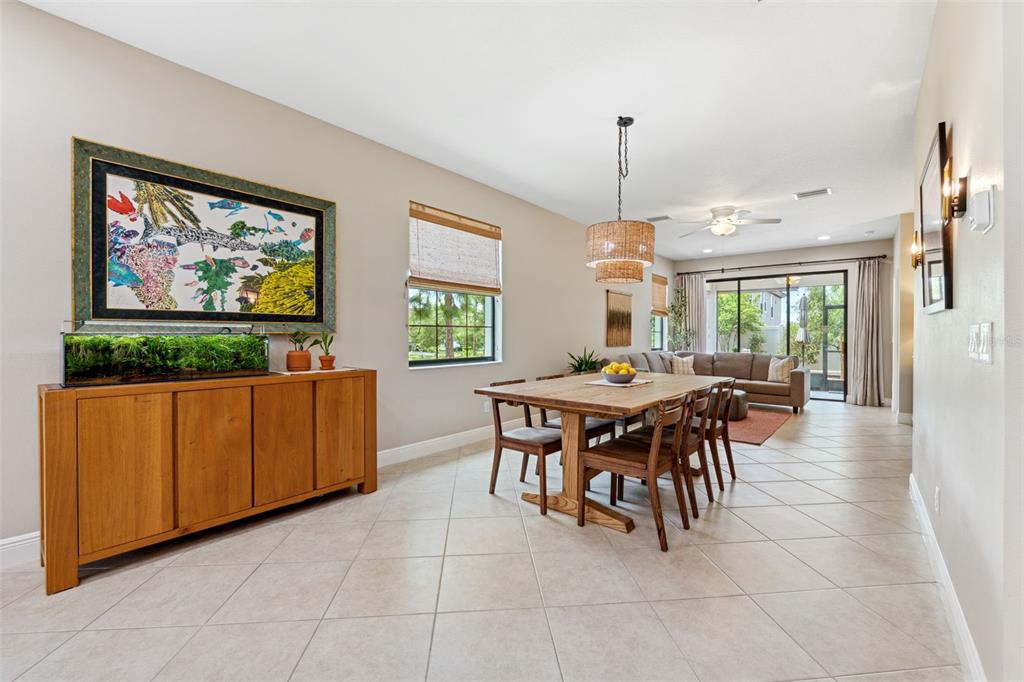 3877 Burdick Loop Odessa, FL 33556 - Photo 13 of 64 a dining room with furniture a window and a kitchen view