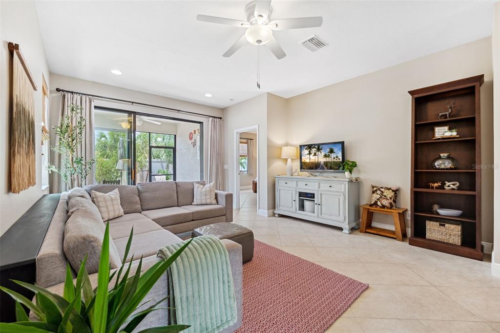 3877 Burdick Loop Odessa, FL 33556 - Photo 15 of 64 a living room with furniture and a large window