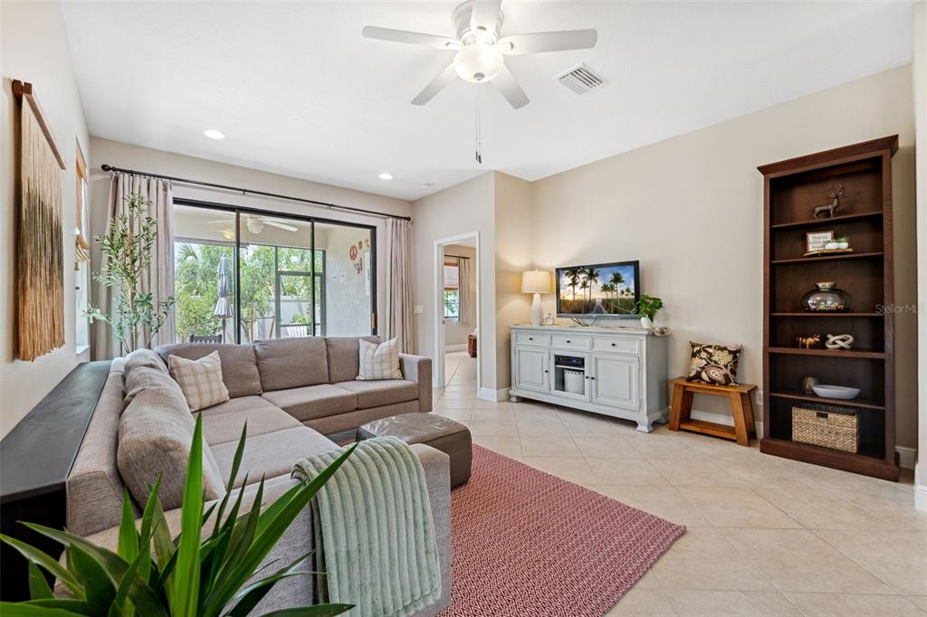 3877 Burdick Loop Odessa, FL 33556 - Photo 16 of 64 a living room with furniture and a large window
