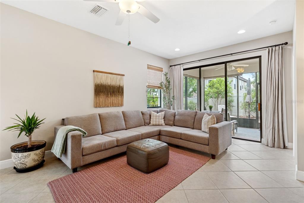 3877 Burdick Loop Odessa, FL 33556 - Photo 18 of 64 a living room with furniture and a large window