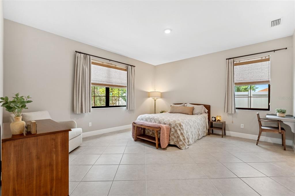 3877 Burdick Loop Odessa, FL 33556 - Photo 23 of 64 a spacious bedroom with a bed and window