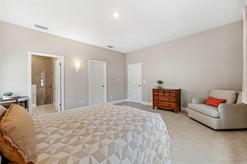 3877 Burdick Loop Odessa, FL 33556 - Photo 25 of 64 a spacious bedroom with a bed and a couch