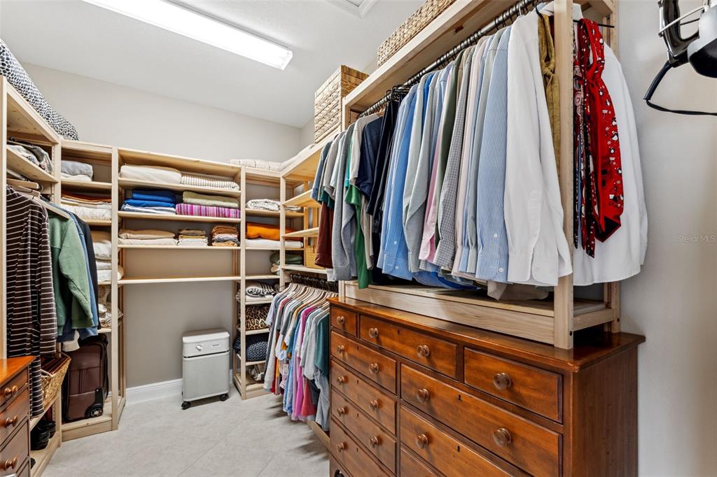 3877 Burdick Loop Odessa, FL 33556 - Photo 27 of 64 a view of walk in closet with clothes and shoes
