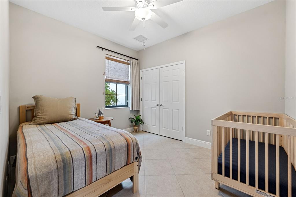 3877 Burdick Loop Odessa, FL 33556 - Photo 29 of 64 a bedroom with a bed and a chandelier