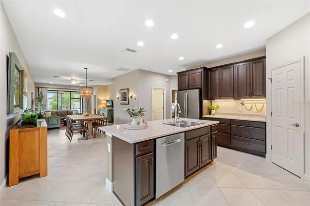 a kitchen with refrigerator and chairs