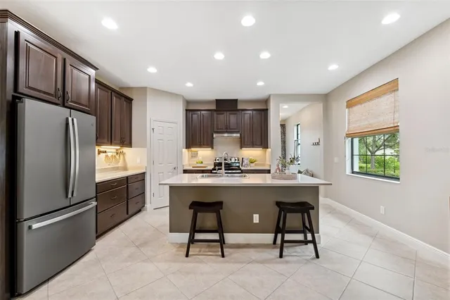 a kitchen with wooden cabinets and stainless steel appliances