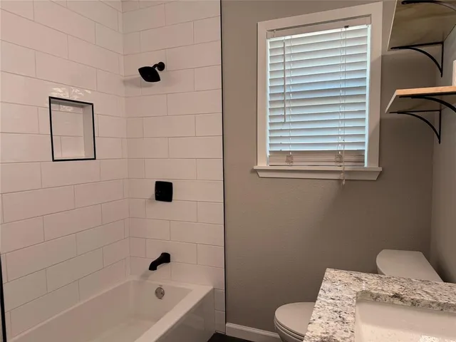 a bathroom with a bathtub and a window