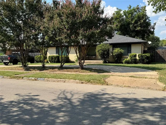 a view of a swimming pool with a lawn chairs under an umbrella