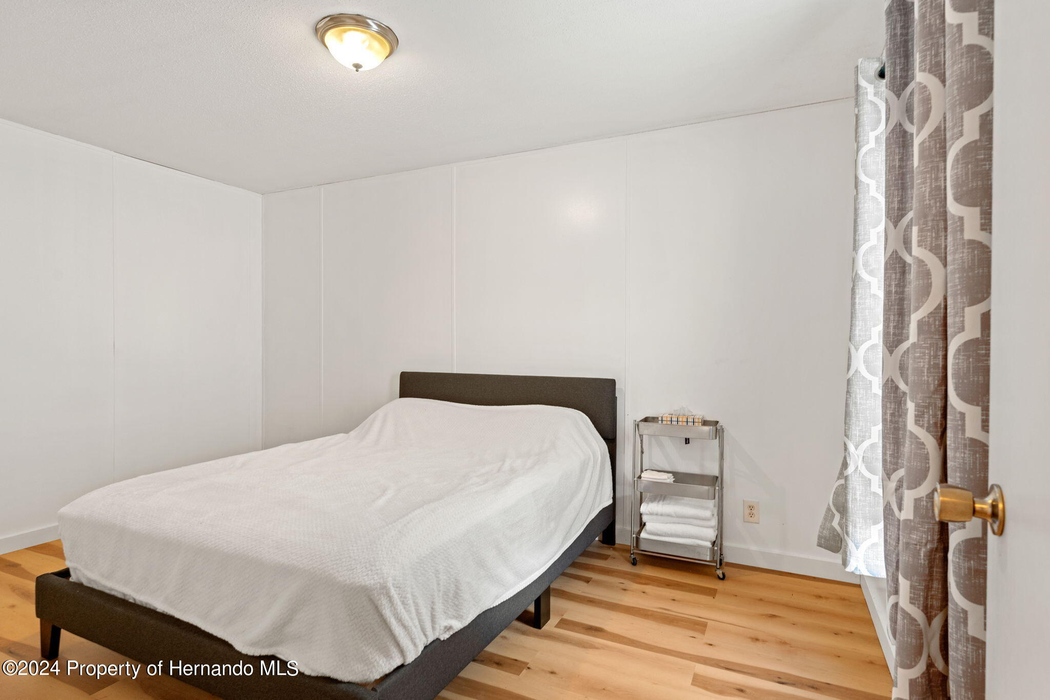 935 South Crystal Grove Point Homosassa, FL 34448 - Photo 14 of 23 a bedroom with a bed and wooden floor