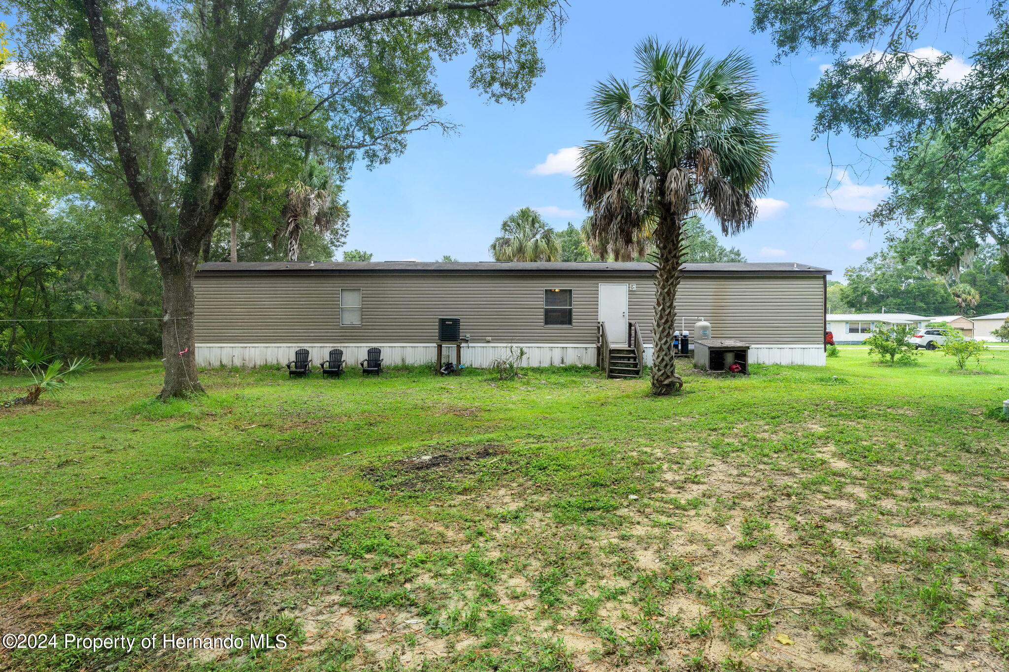 935 South Crystal Grove Point Homosassa, FL 34448 - Photo 19 of 23 a front view of house with a garden and trees