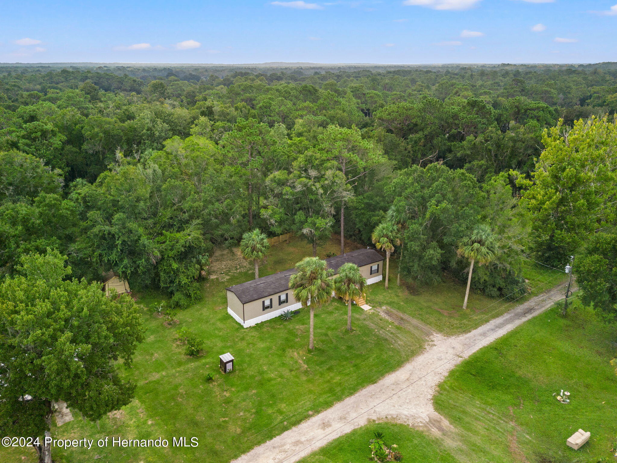 935 South Crystal Grove Point Homosassa, FL 34448 - Photo 2 of 23 a view of a garden with a building in the background