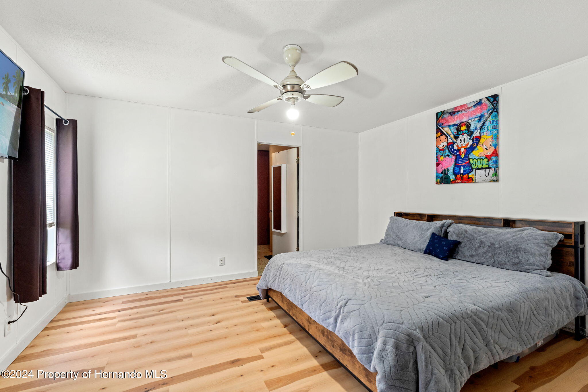 935 South Crystal Grove Point Homosassa, FL 34448 - Photo 7 of 23 a bedroom with a bed and a chandelier