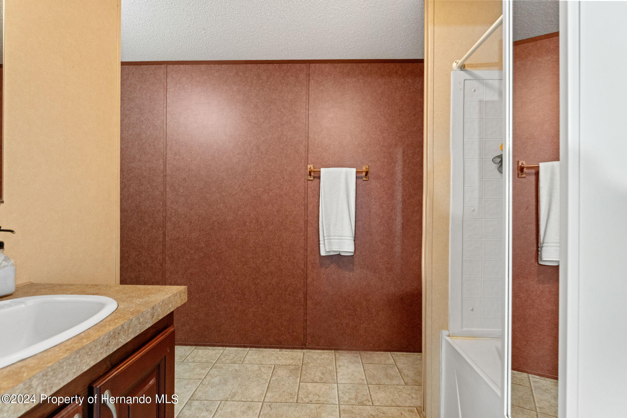 935 South Crystal Grove Point Homosassa, FL 34448 - Photo 9 of 23 a bathroom with a granite countertop sink and a bathtub