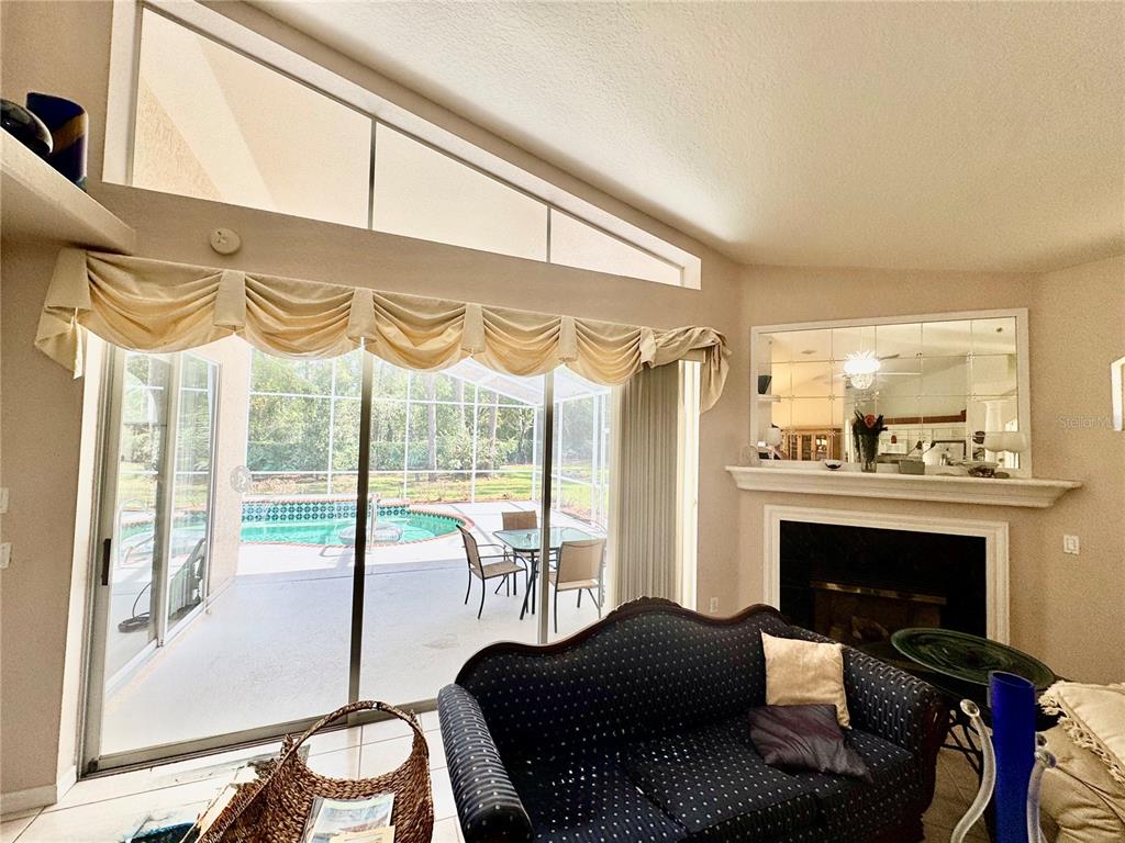 5688 Legend Hills Lane Spring Hill, FL 34609 - Photo 11 of 74 a livingroom with furniture window and a fireplace