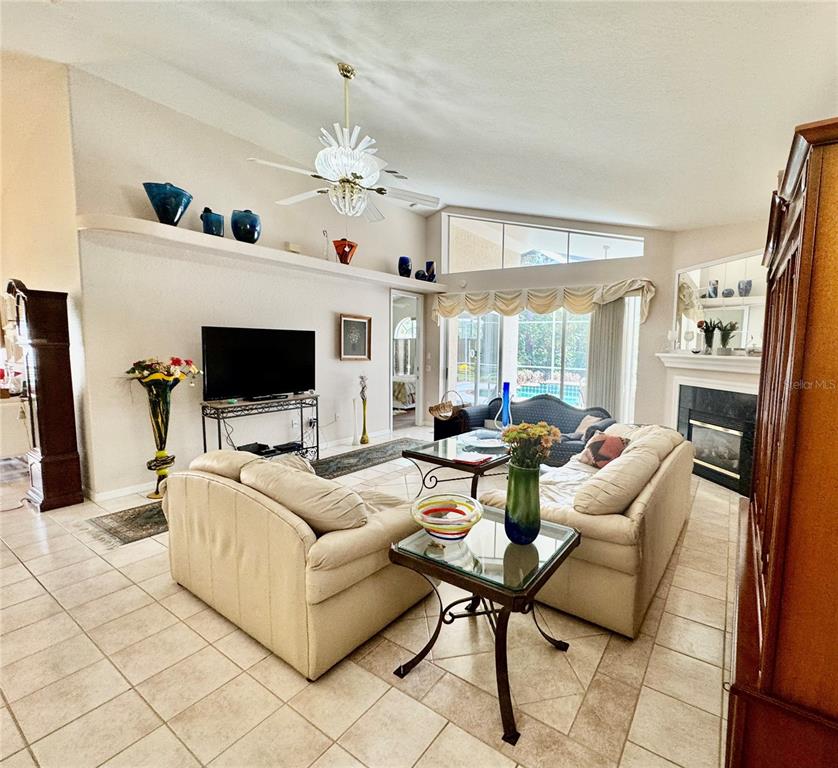 5688 Legend Hills Lane Spring Hill, FL 34609 - Photo 14 of 74 a living room with furniture and a flat screen tv