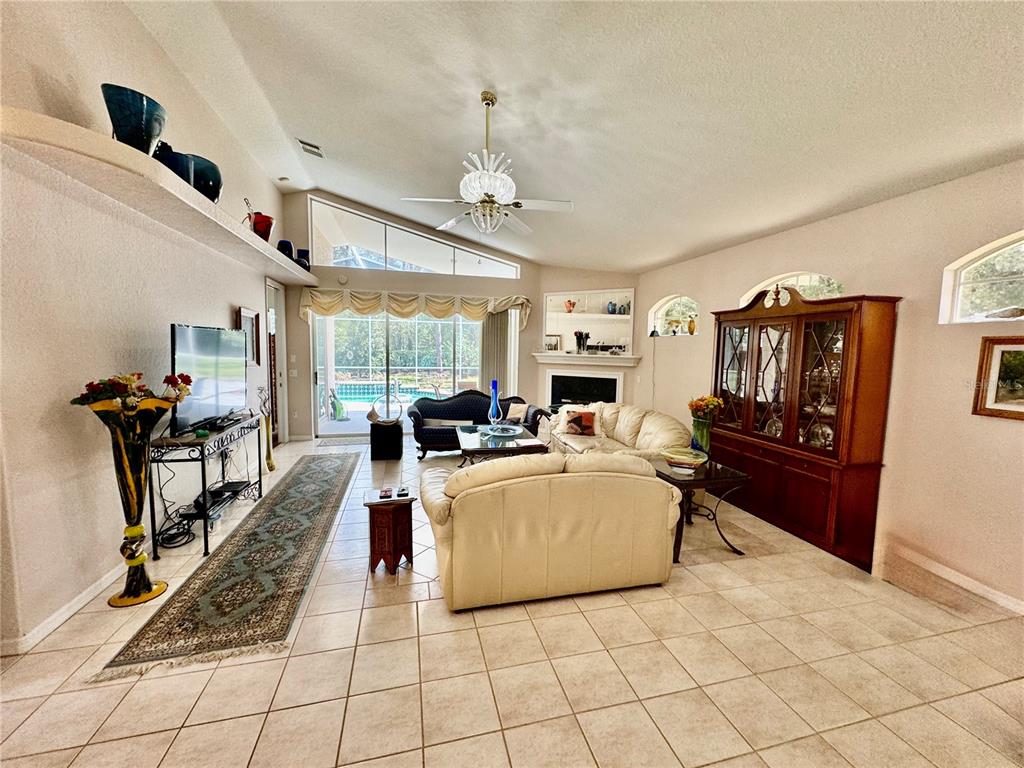 5688 Legend Hills Lane Spring Hill, FL 34609 - Photo 15 of 74 a living room with furniture and a flat screen tv