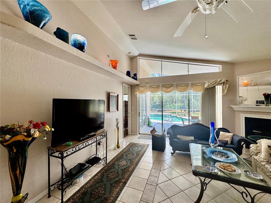 5688 Legend Hills Lane Spring Hill, FL 34609 - Photo 16 of 74 a living room with furniture and a flat screen tv
