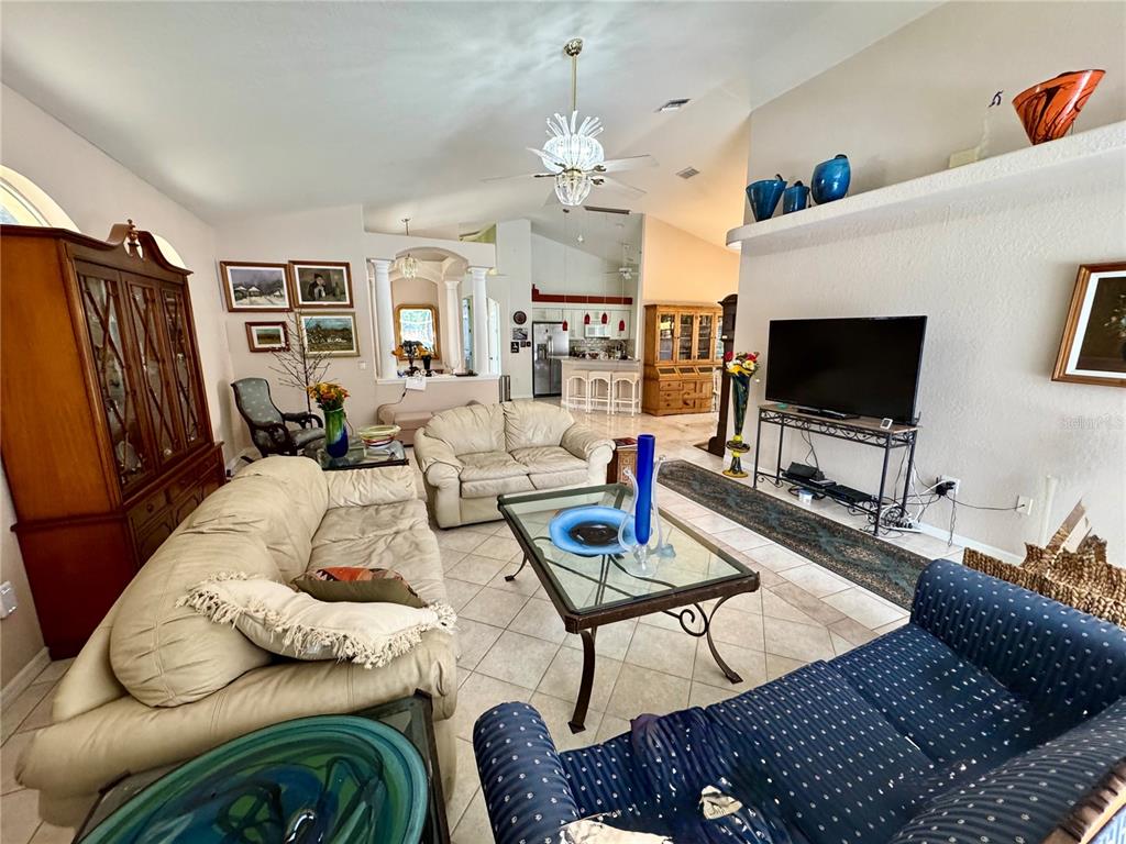 5688 Legend Hills Lane Spring Hill, FL 34609 - Photo 17 of 74 a living room with furniture fireplace and a flat screen tv