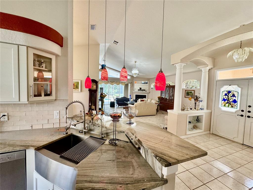 5688 Legend Hills Lane Spring Hill, FL 34609 - Photo 25 of 74 a very nice looking kitchen with granite countertop a sink white cabinets and a stove