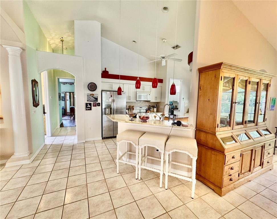 5688 Legend Hills Lane Spring Hill, FL 34609 - Photo 26 of 74 a kitchen with stainless steel appliances kitchen island granite countertop a sink and cabinets