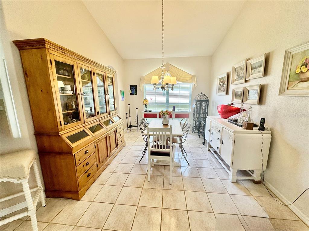 5688 Legend Hills Lane Spring Hill, FL 34609 - Photo 27 of 74 a living room with furniture a flat screen tv and a table
