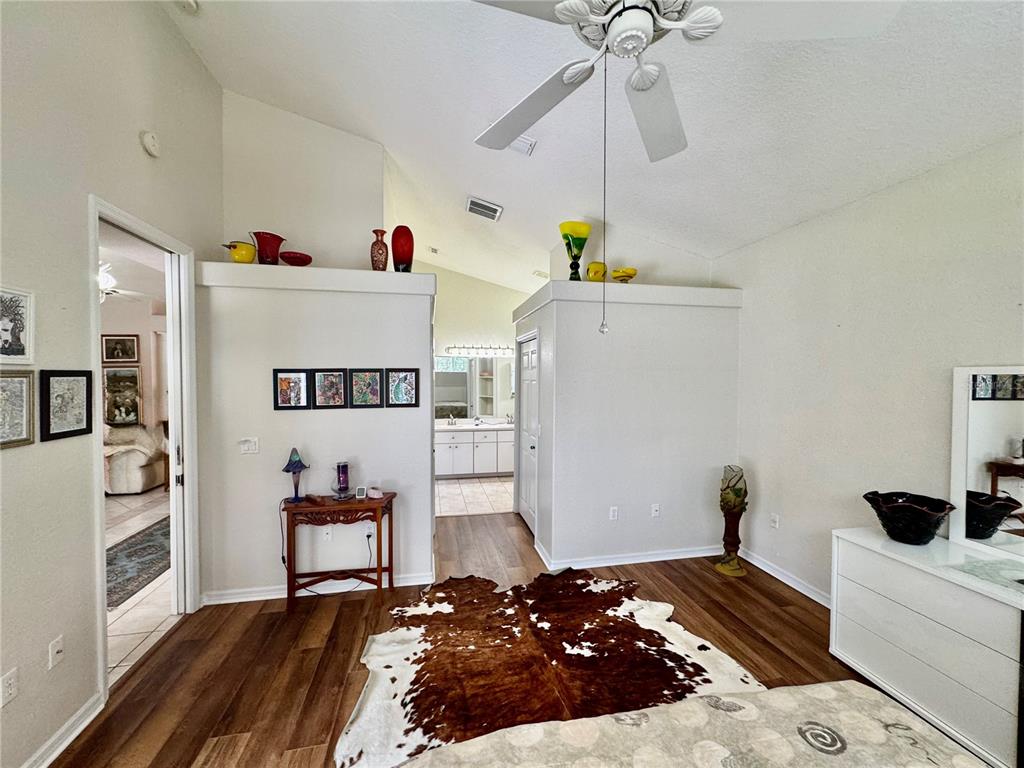 5688 Legend Hills Lane Spring Hill, FL 34609 - Photo 31 of 74 a bedroom with a bed and cabinets