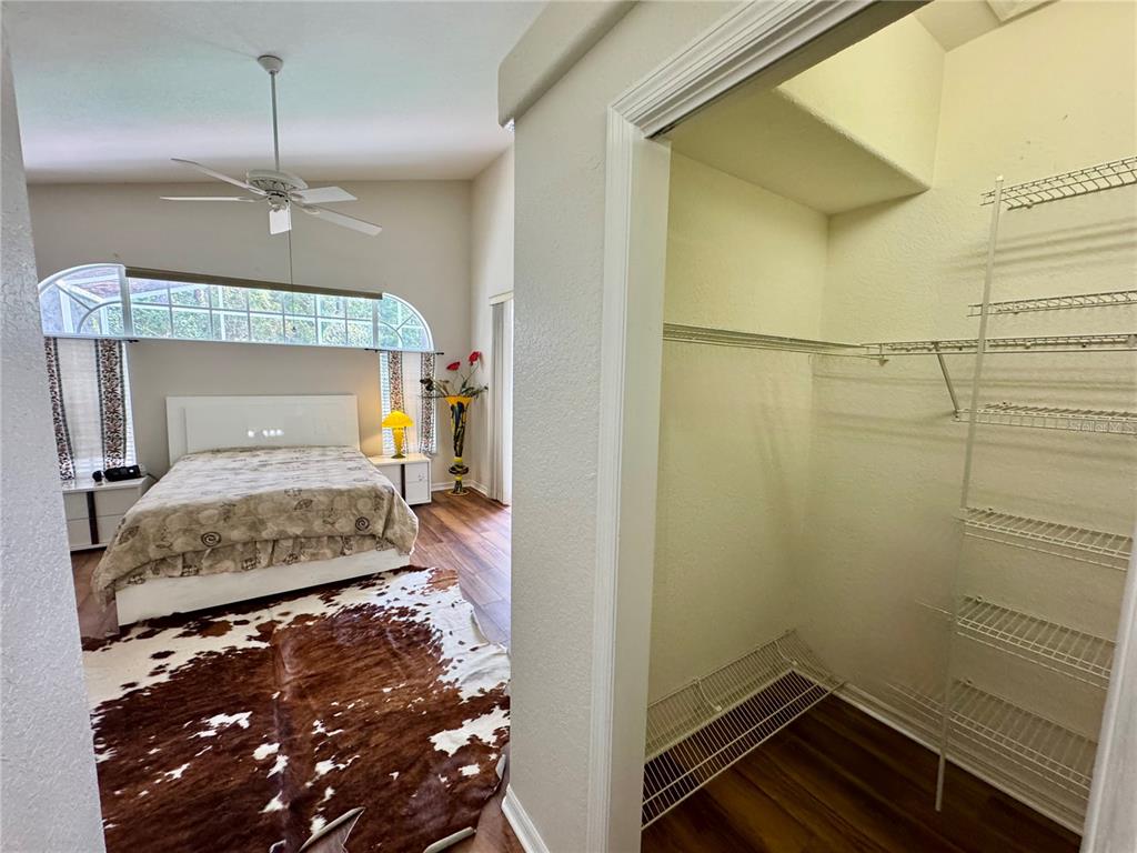 5688 Legend Hills Lane Spring Hill, FL 34609 - Photo 32 of 74 a bedroom with a bed and a mirror