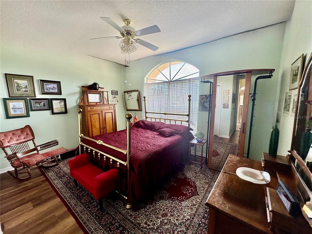 5688 Legend Hills Lane Spring Hill, FL 34609 - Photo 34 of 74 a bedroom with furniture and a mirror