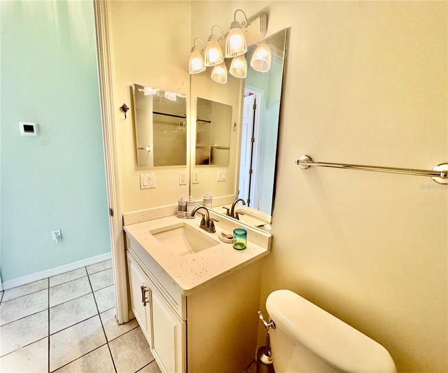 5688 Legend Hills Lane Spring Hill, FL 34609 - Photo 38 of 74 a bathroom with a sink mirror vanity and toilet