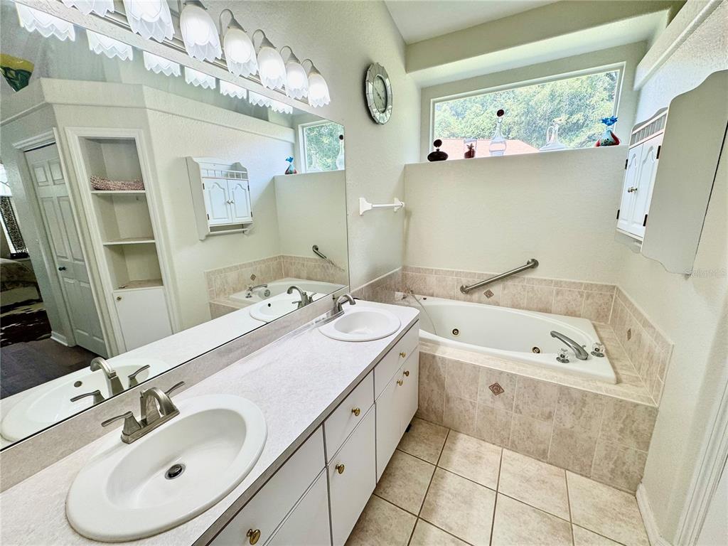 5688 Legend Hills Lane Spring Hill, FL 34609 - Photo 39 of 74 a spacious bathroom with a double vanity sink mirror and double