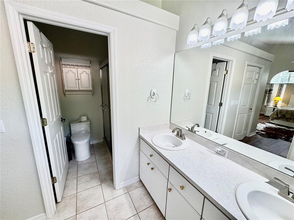 5688 Legend Hills Lane Spring Hill, FL 34609 - Photo 40 of 74 a spacious bathroom with a double vanity sink and a mirror