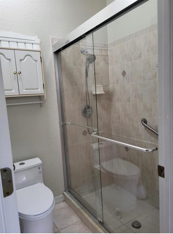 5688 Legend Hills Lane Spring Hill, FL 34609 - Photo 41 of 74 a bathroom with a toilet and a shower