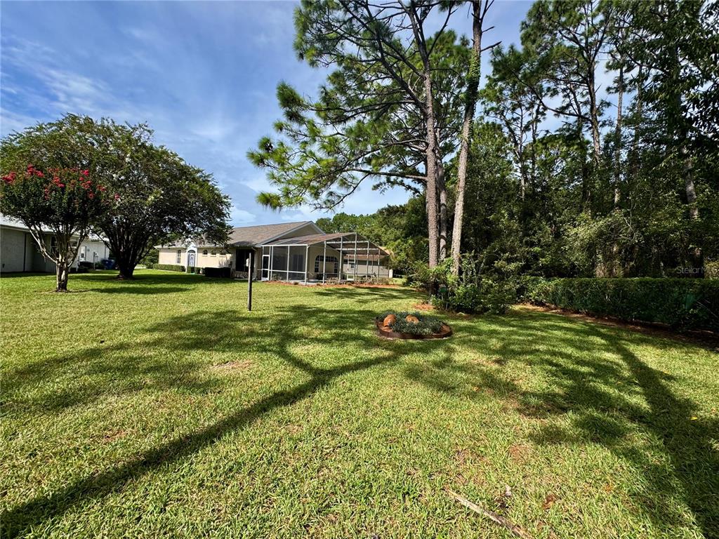 5688 Legend Hills Lane Spring Hill, FL 34609 - Photo 49 of 74 a view of a house with a yard