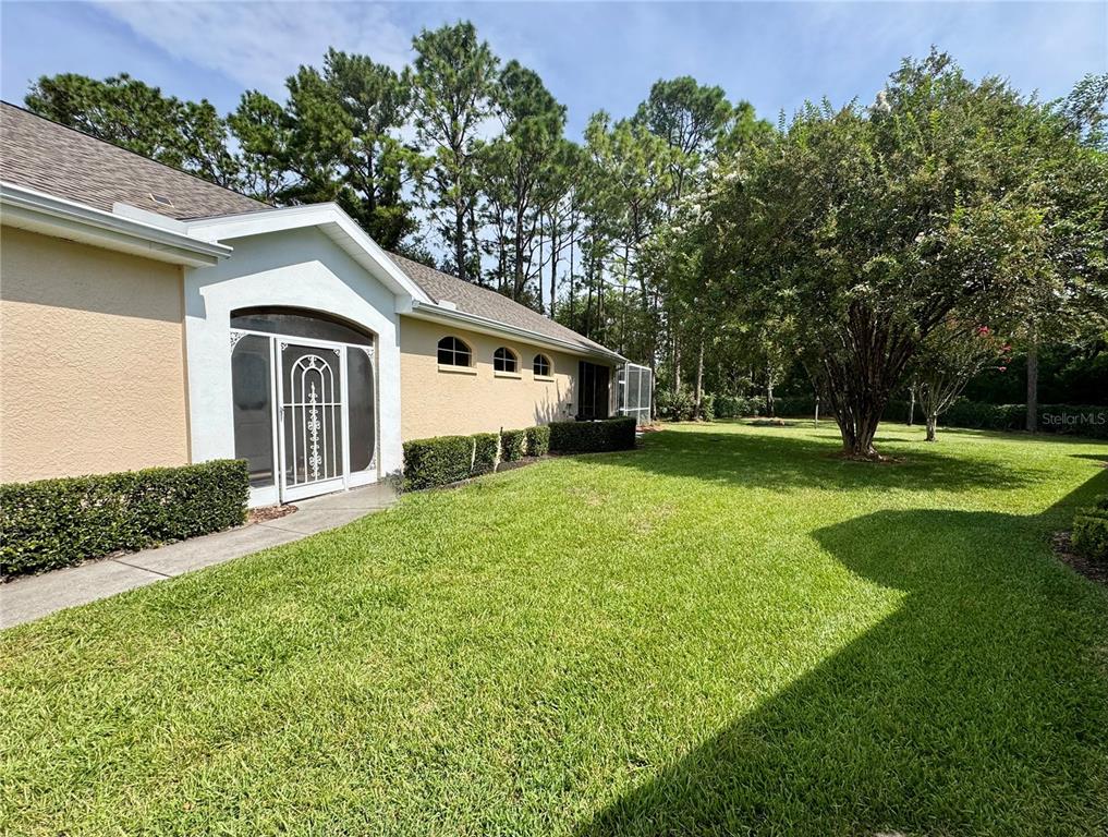 5688 Legend Hills Lane Spring Hill, FL 34609 - Photo 51 of 74 a front view of a house with garden