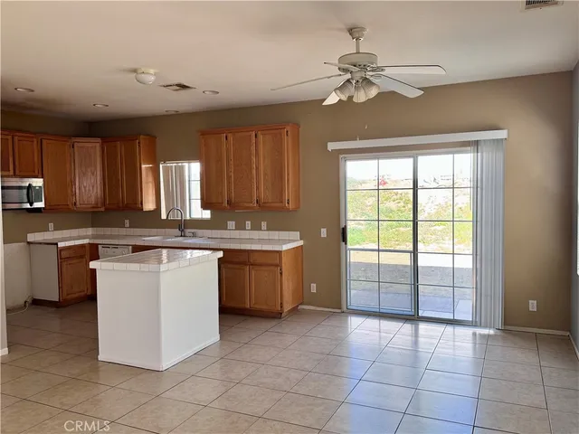 a large kitchen with a large window appliances and cabinets