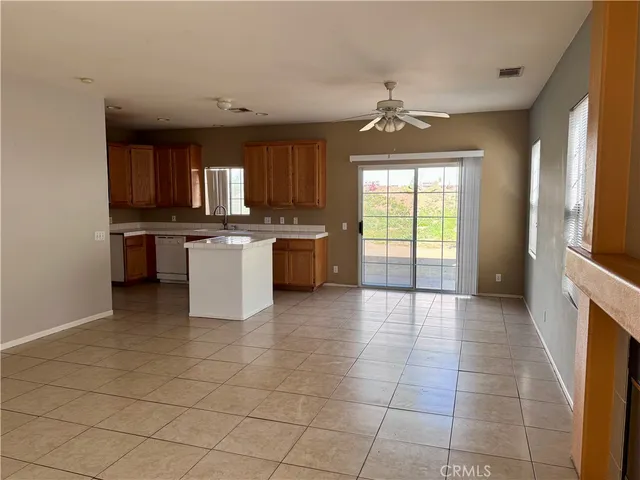 a kitchen with a sink a stove and cabinets