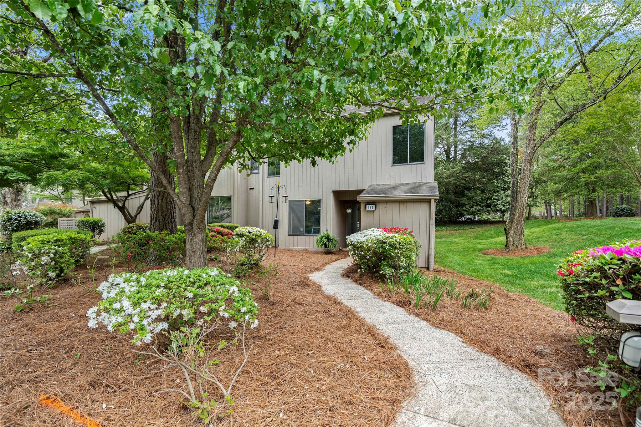 a front view of a house with garden