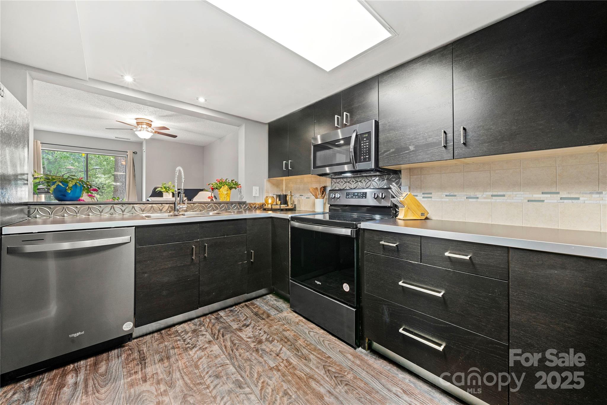 181 Riverview Terrace Clover, SC 29710 - Photo 11 of 43 a kitchen with stainless steel appliances kitchen island granite countertop a sink stove and cabinets