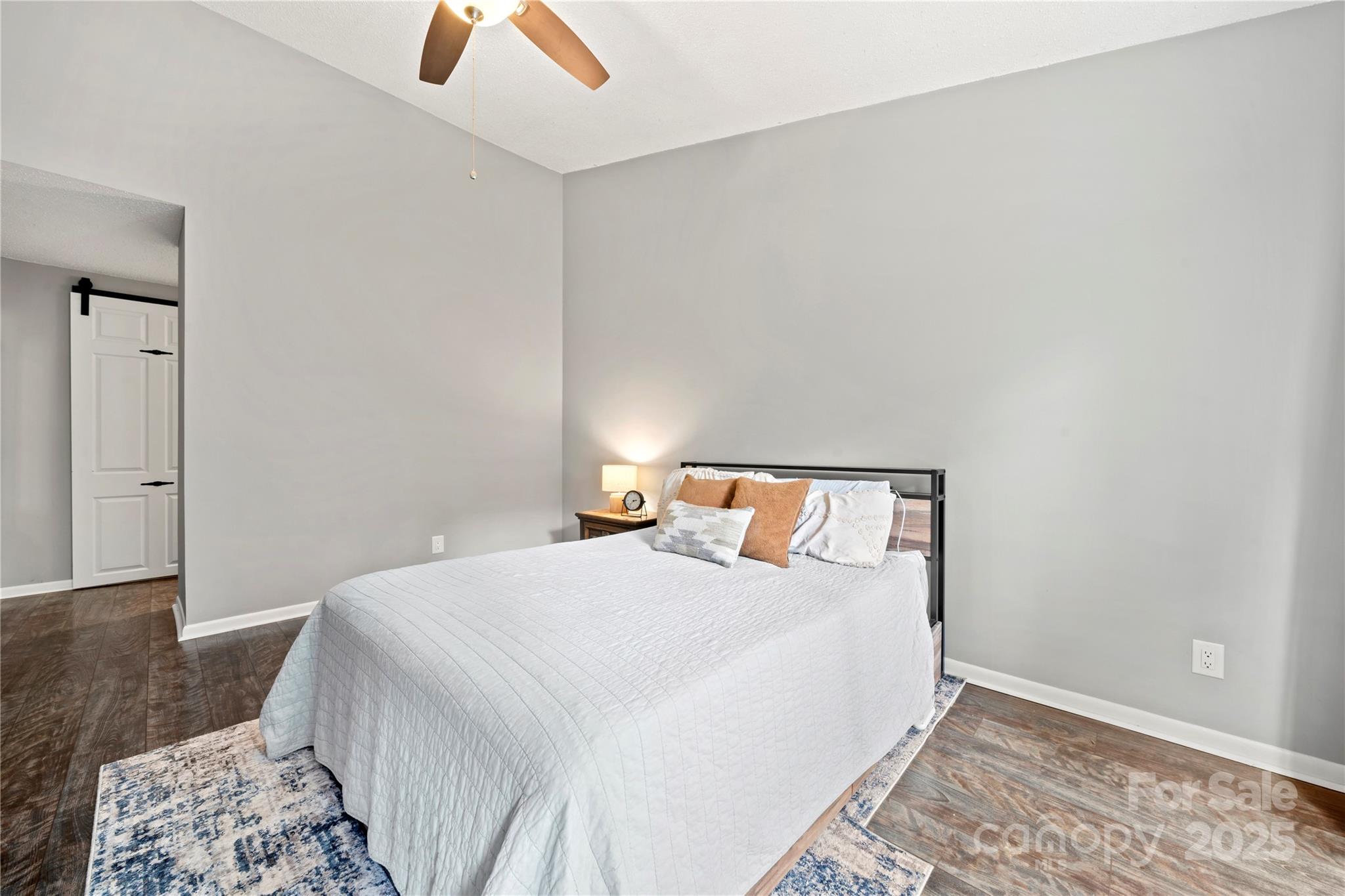 181 Riverview Terrace Clover, SC 29710 - Photo 27 of 43 a bedroom with a bed and a lamp with the wooden floor