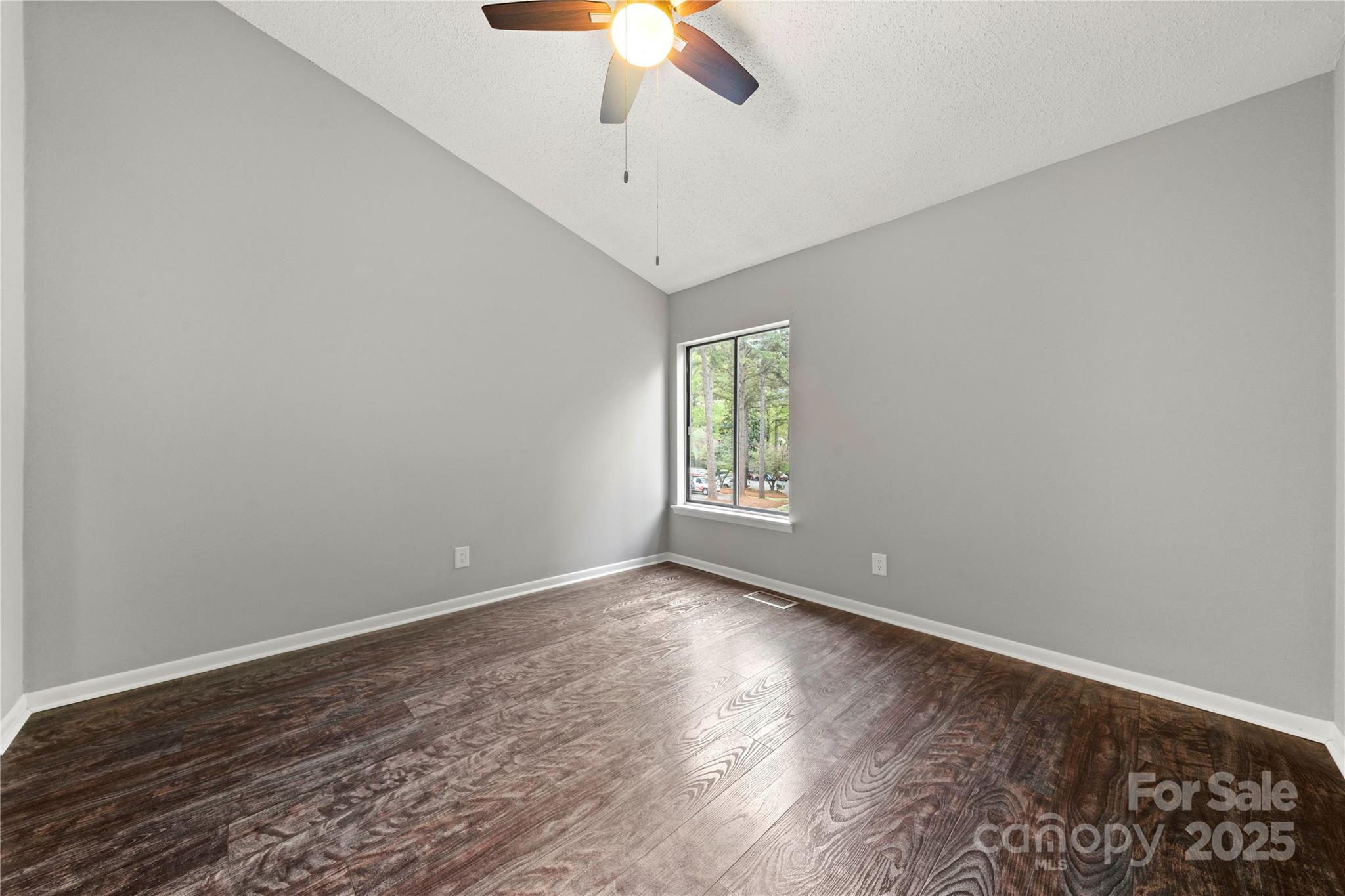 181 Riverview Terrace Clover, SC 29710 - Photo 29 of 43 an empty room with windows and chandelier fan