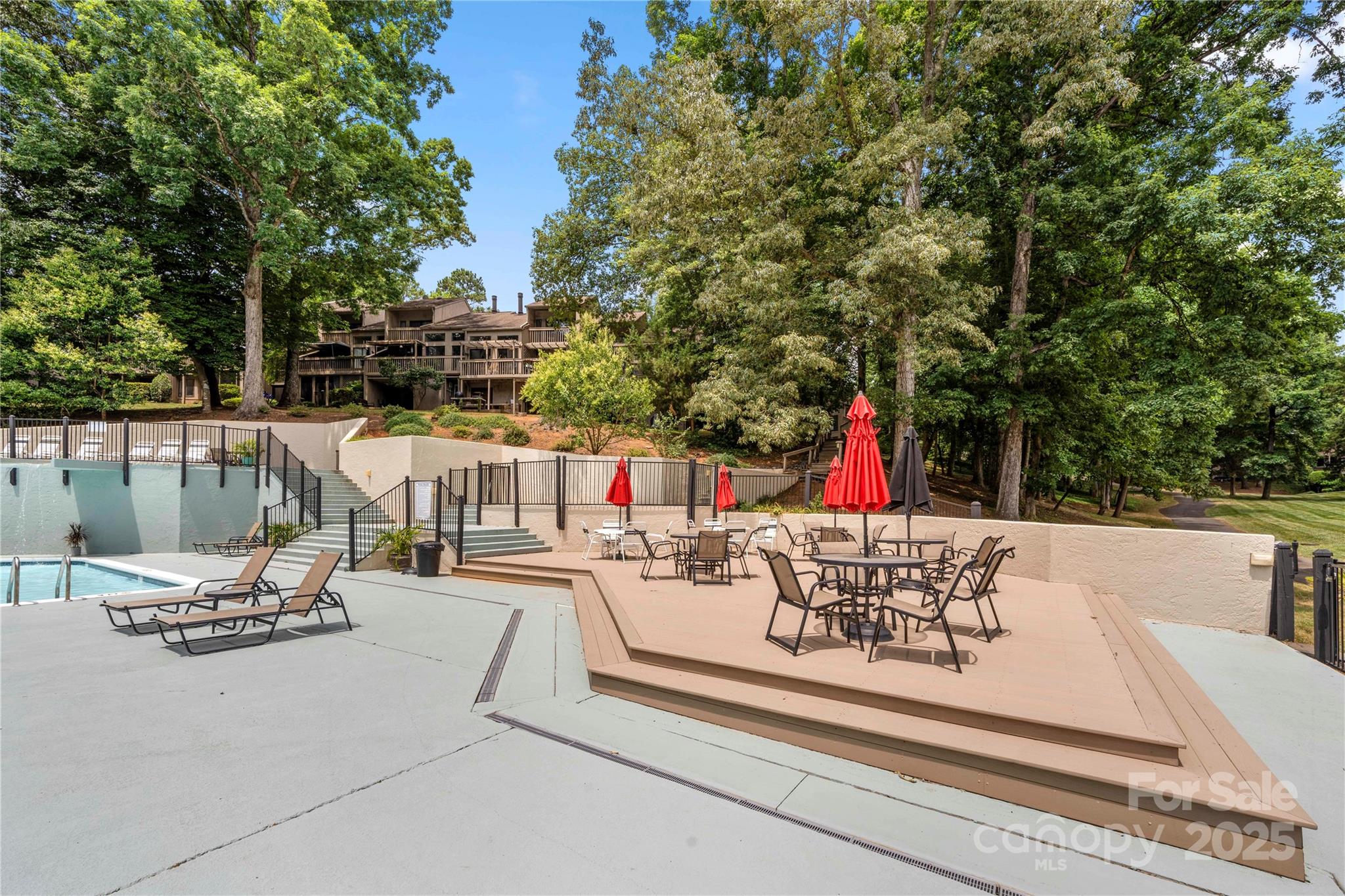 181 Riverview Terrace Clover, SC 29710 - Photo 40 of 43 a view of a patio with table and chairs potted plants and large tree