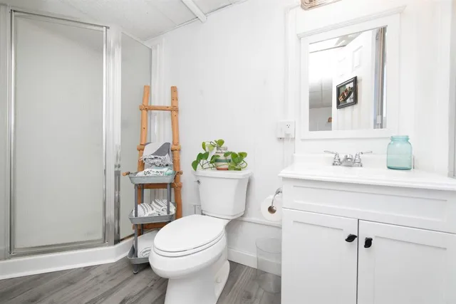 a bathroom with a sink a toilet and a mirror