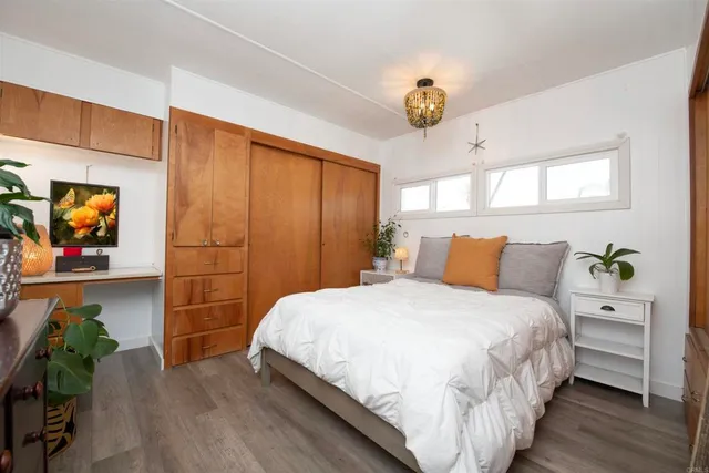 a bedroom with bed and a chandelier