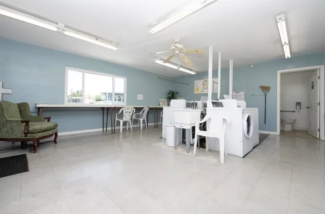 a large kitchen with a table and chairs
