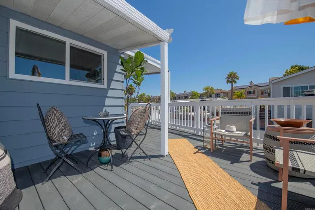 a view of a roof deck with chair and potted plant