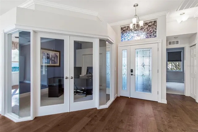 a view of a dining room with furniture and a chandelier