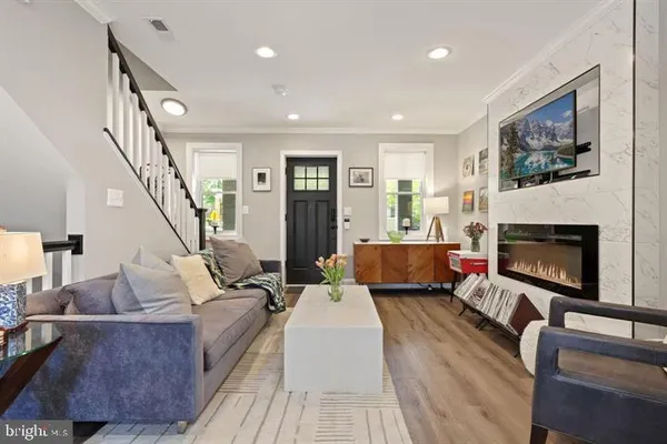 a living room with furniture and a fireplace