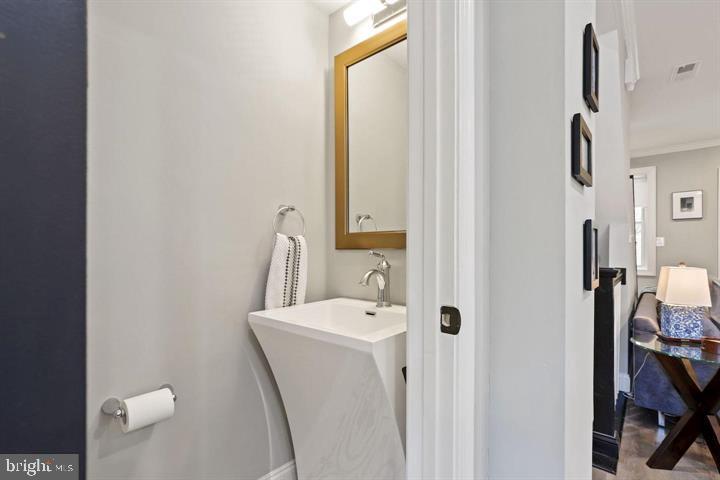 1634 Ridge Place Southeast Washington, DC 20020 - Photo 12 of 27 a bathroom with a sink and a mirror