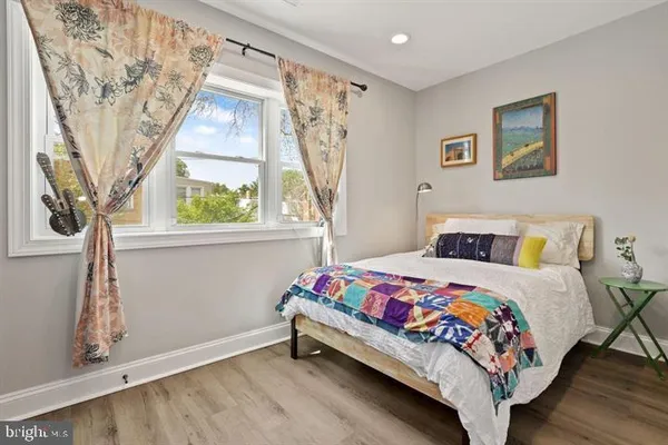 a bedroom with a bed and a window with painted walls