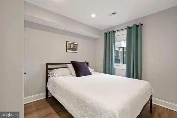 a bedroom with a large bed and a window